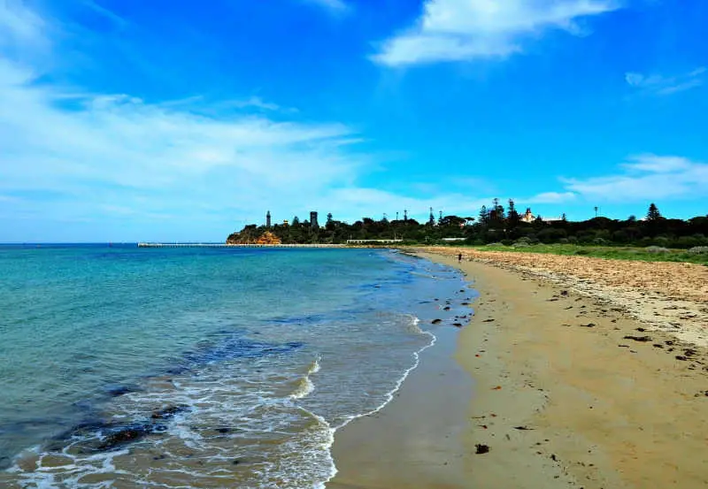 View of the beach at Queenscliff with the lighhthouse in the distance.