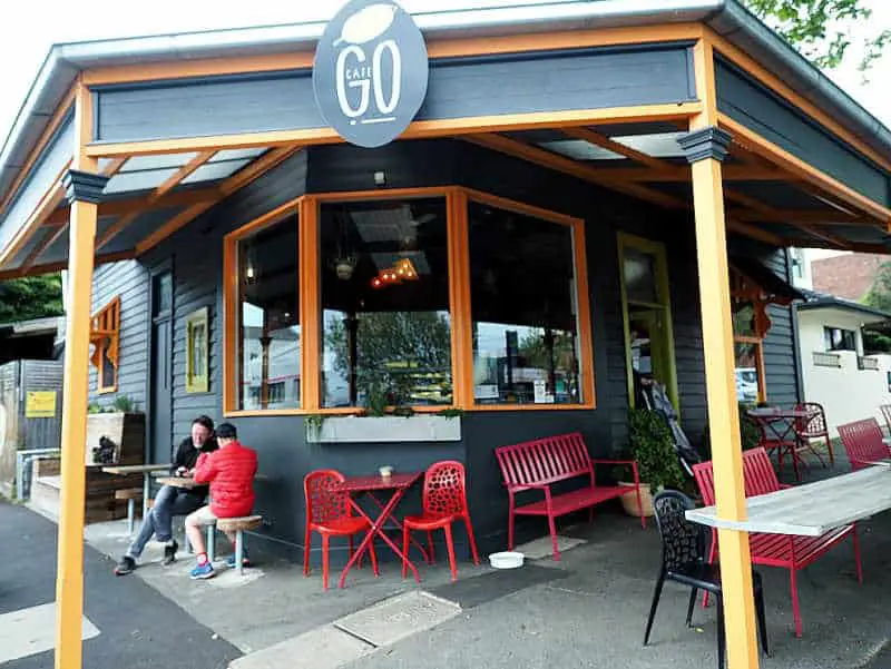 Two people drinking coffee at the outdoor tables at Cafe Go Geelong