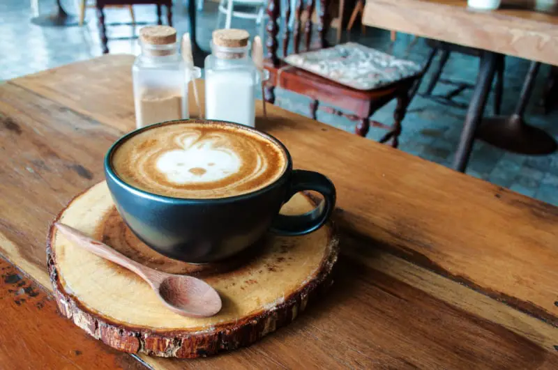 Latte coffee and salt and pepper shakers at one of the cafes in Ocean Grove Australia.