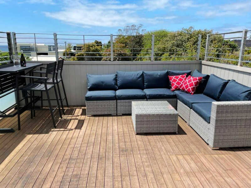 Deck with blue sky and outdoor seating at Calypso Retreat a great place to stay in Portarlington.