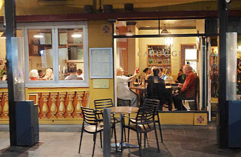 View through a window at diners enjoying a feast at Caruggi Italian restaurant in Geelong.