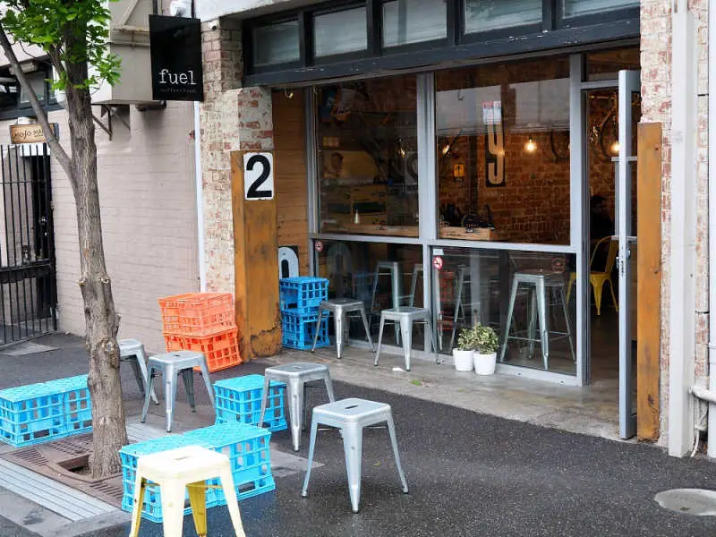 Outdoor seating area with tree at Fuel Geelong cafe.