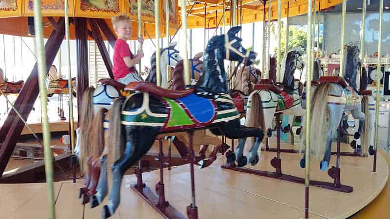 Child riding the Geelong Carousel. One of the fun things to do in Geelong with kids.