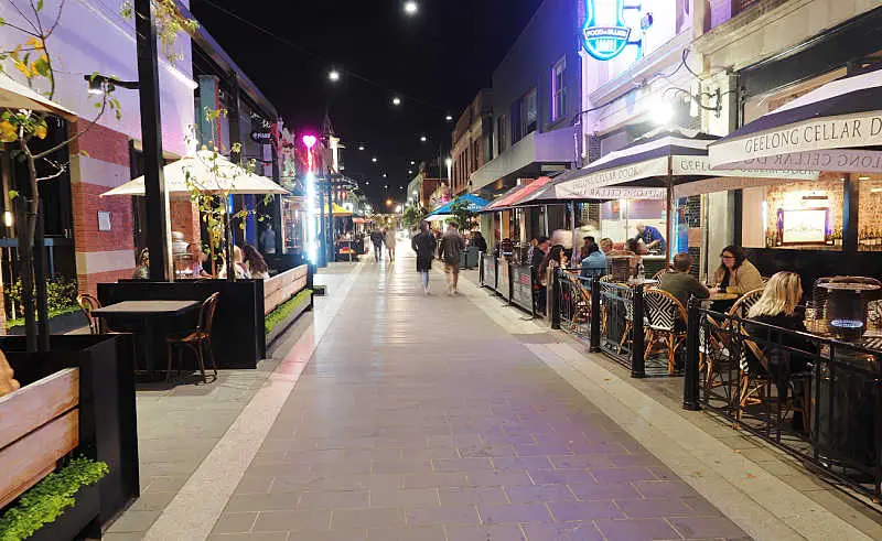 People walking down Little Malop Street Geelong at night.