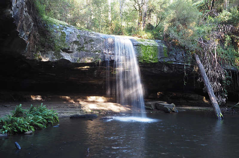 Water flowing over a rock ledge into a calm plunge at Lower Kalimna Falls near Lorne Australia. 