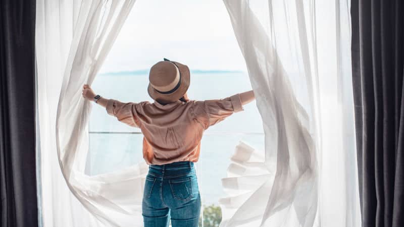 Woman enjoying the view from her luxury accommodation in Geelong.