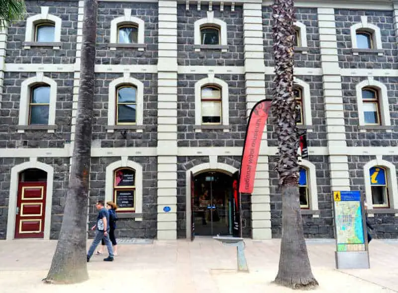 People walking past the National Wool Museum entrance.