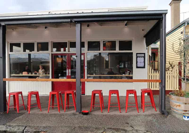 Image of Nivana Queenscliff one of the most popular Asian restaurants in Queenscliff with red stools under the verandah in the outdoor dining area.