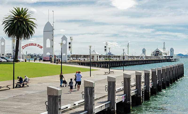 Image of a family walking along the Geelong waterfront at Cunningham Pier. One of the fun things to do in Geelong for kids.