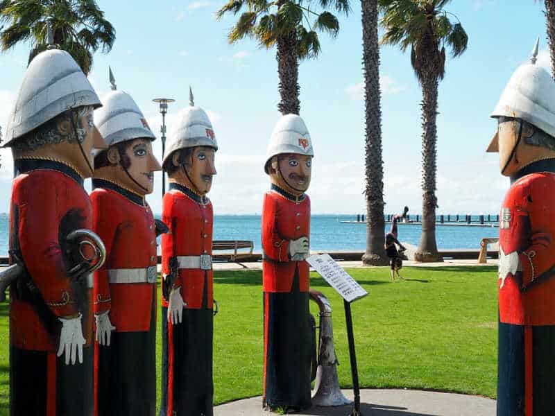 Volunteer Rifle Band Bollards on Geelong Waterfront with a person doing a handstand in the background.