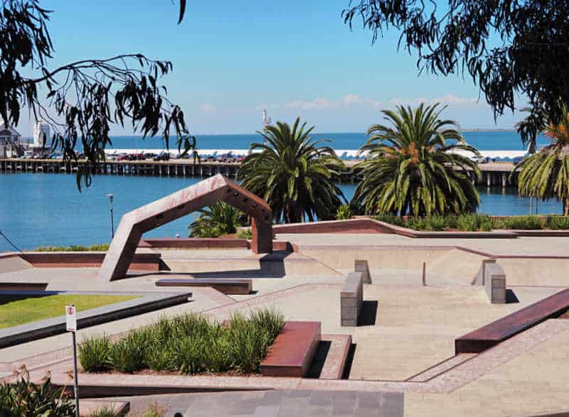 Geelong Skate Park with palm trees and Cunningham Pier in the background.